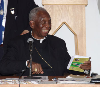 Cardinal Agre with Economic Democracy book