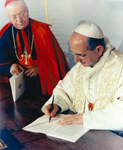 Paul VI signing Populorum progressio
